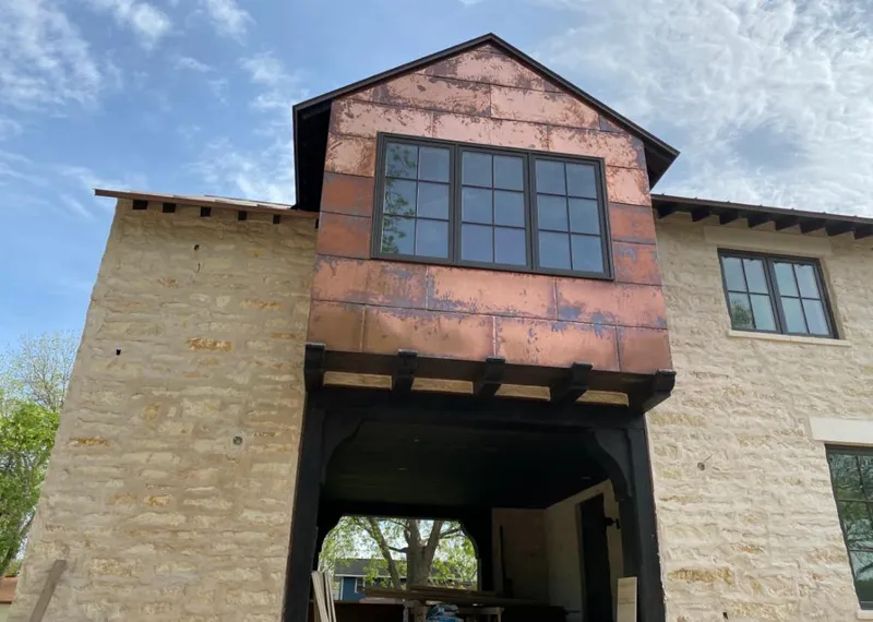 Copper metal panel facade on a stone building for Skylight Installation in Waycross